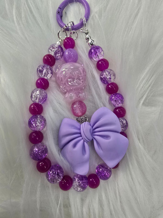 Purple Dimo and bow phone charm